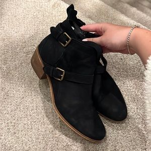 Black bootie with clip detailing on side